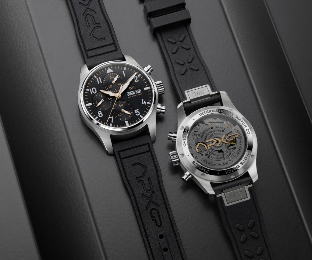 Two IWC APXGP Chronograph models - 43mm Ref. IW378009 and 41mm Ref. IW388116 with black dials, gold-plated hands, white numerals, and black rubber straps featuring the APXGP team logo.