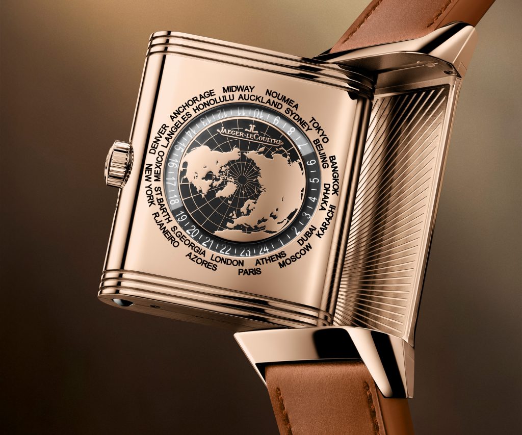 Reverse side of pink gold Jaeger-LeCoultre Reverso Geographic showing the intricate world time display with laser-cut map, city names engraved on the case back, and rotating 24-hour indicator ring.