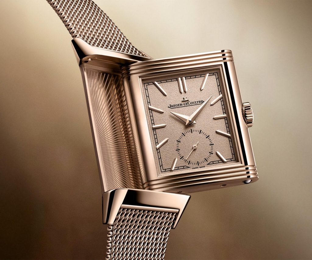 Jaeger-LeCoultre Reverso Tribute Monoface Small Seconds timepiece with 18k pink gold case, golden grained dial, and intricately woven Milanese bracelet shown from front view with small seconds at 6 o'clock.