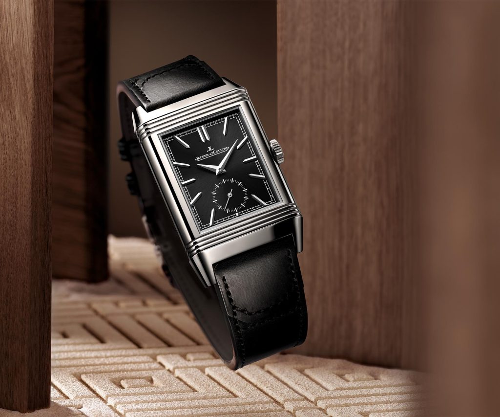 Jaeger-LeCoultre Reverso Tribute Duoface Small Seconds with black sunray dial, applied hour markers, Dauphine hands, and small seconds at 6 o'clock in a steel case.