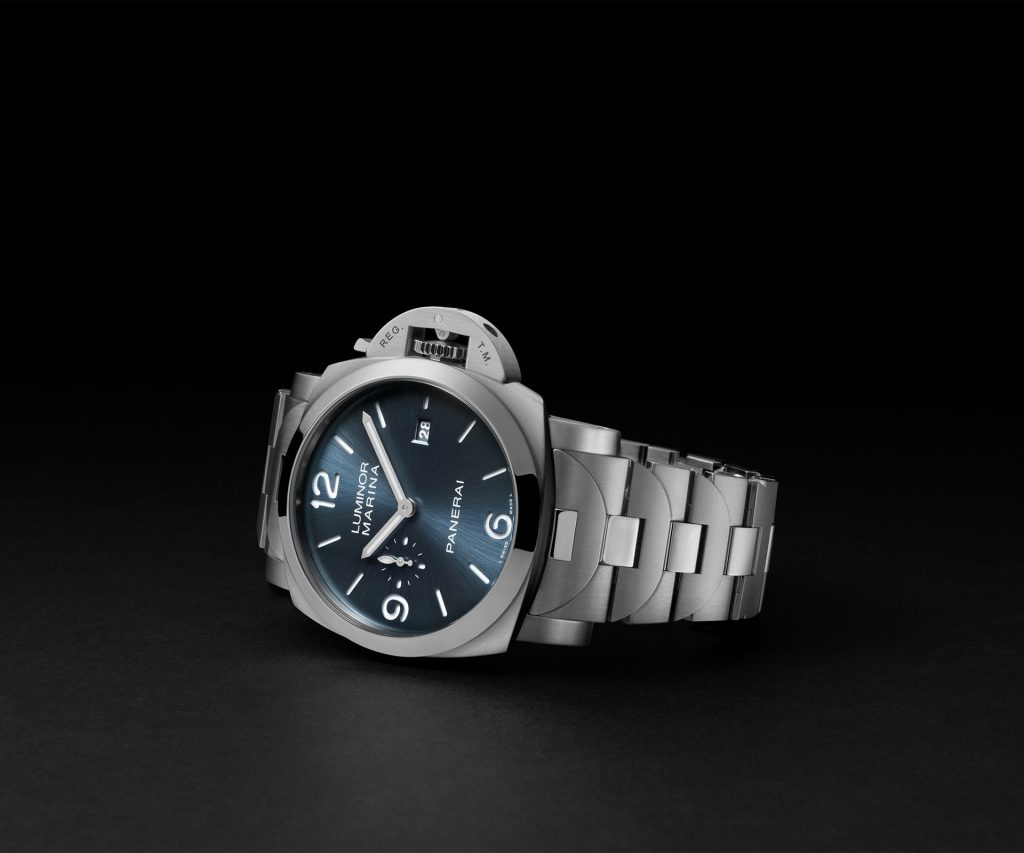 Panerai Luminor Marina PAM03323 featuring 44mm steel case, light blue sun-brushed sandwich dial, white Super-LumiNova® X2 markers, and polished steel bezel with brushed case.